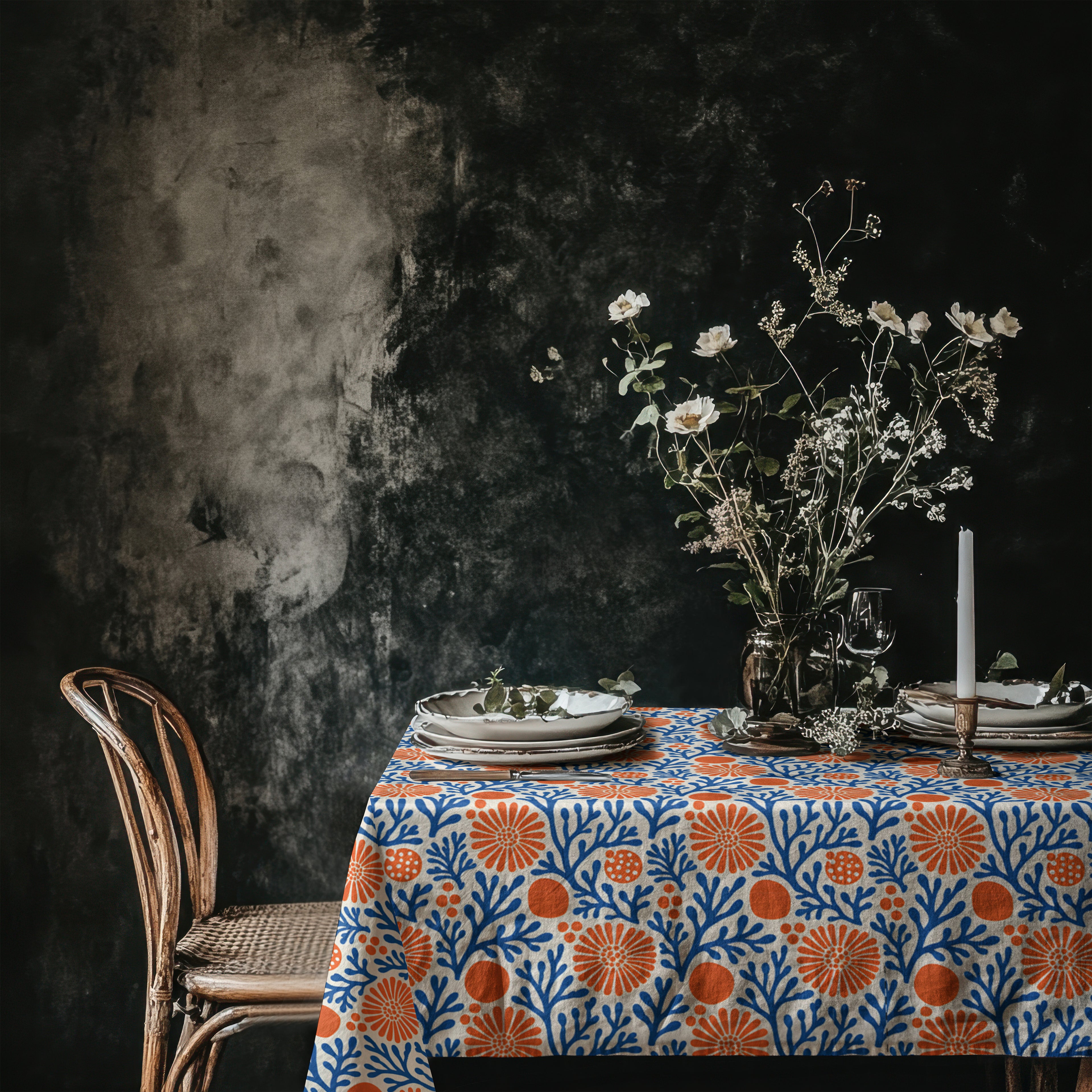 Blue and terracotta coral reef tablecloth creating a vibrant Mediterranean-inspired dining table.
