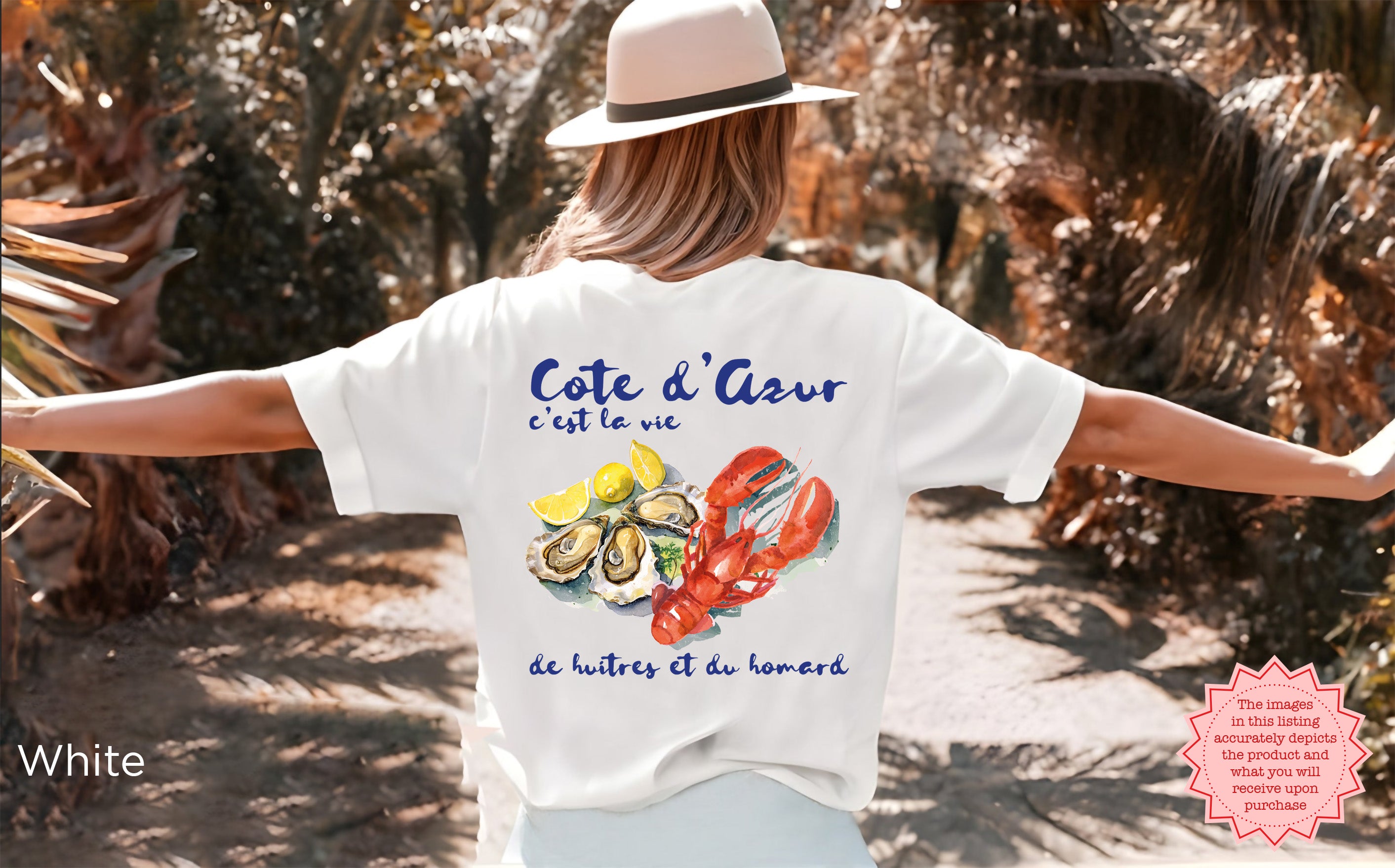 White Cote d’Azur t-shirt with watercolor lobster, oysters, and lemons design, worn outdoors with arms outstretched, coastal vacation style and ideal gift for seafood and lobster lovers.