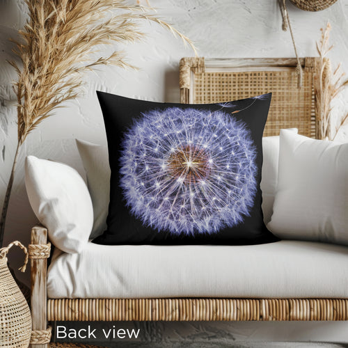 Back view of the Detailed Dandelion Cushion with the same beautiful dandelion design on the black background. The cushion is displayed on a minimalist sofa with white cushions and woven décor accents.