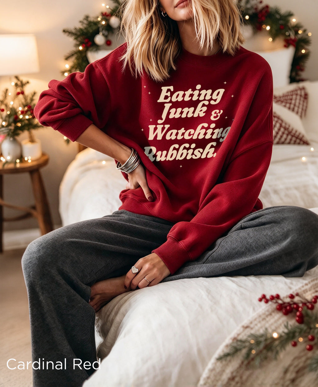 Retro Christmas sweatshirt with “Eating Junk & Watching Rubbish” text, styled for a festive holiday movie night.