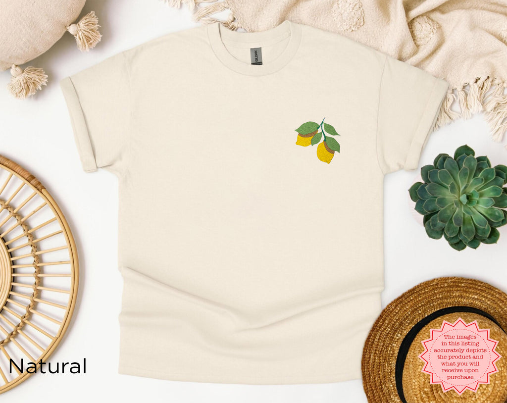 Folded embroidered lemon t-shirt showing lemon and green leaf chest design