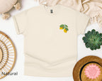 Folded embroidered lemon t-shirt showing lemon and green leaf chest design