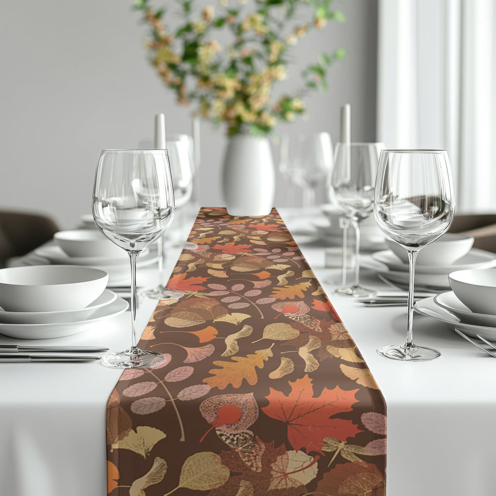 Autumn botanical leaf table runner featuring warm rust, brown, gold, and green tones