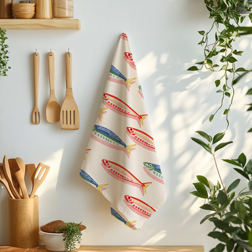 Coastal kitchen towel with repeating illustrated fish design inspired by Mediterranean fishing markets and seaside homes.
