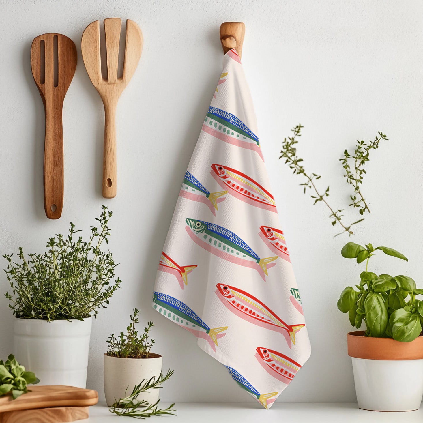 Microfiber tea towel featuring a repeating fish print design, ideal for seafood lovers and coastal home interiors.
