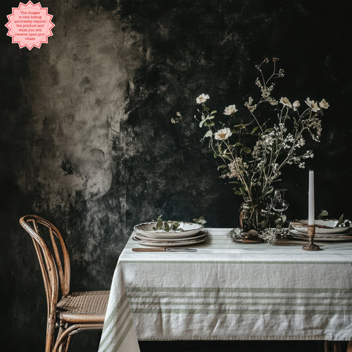 French Riviera Sage Stripe Tablecloth featuring soft sage green stripes on premium cotton twill, styled in a modern Mediterranean dining setting.