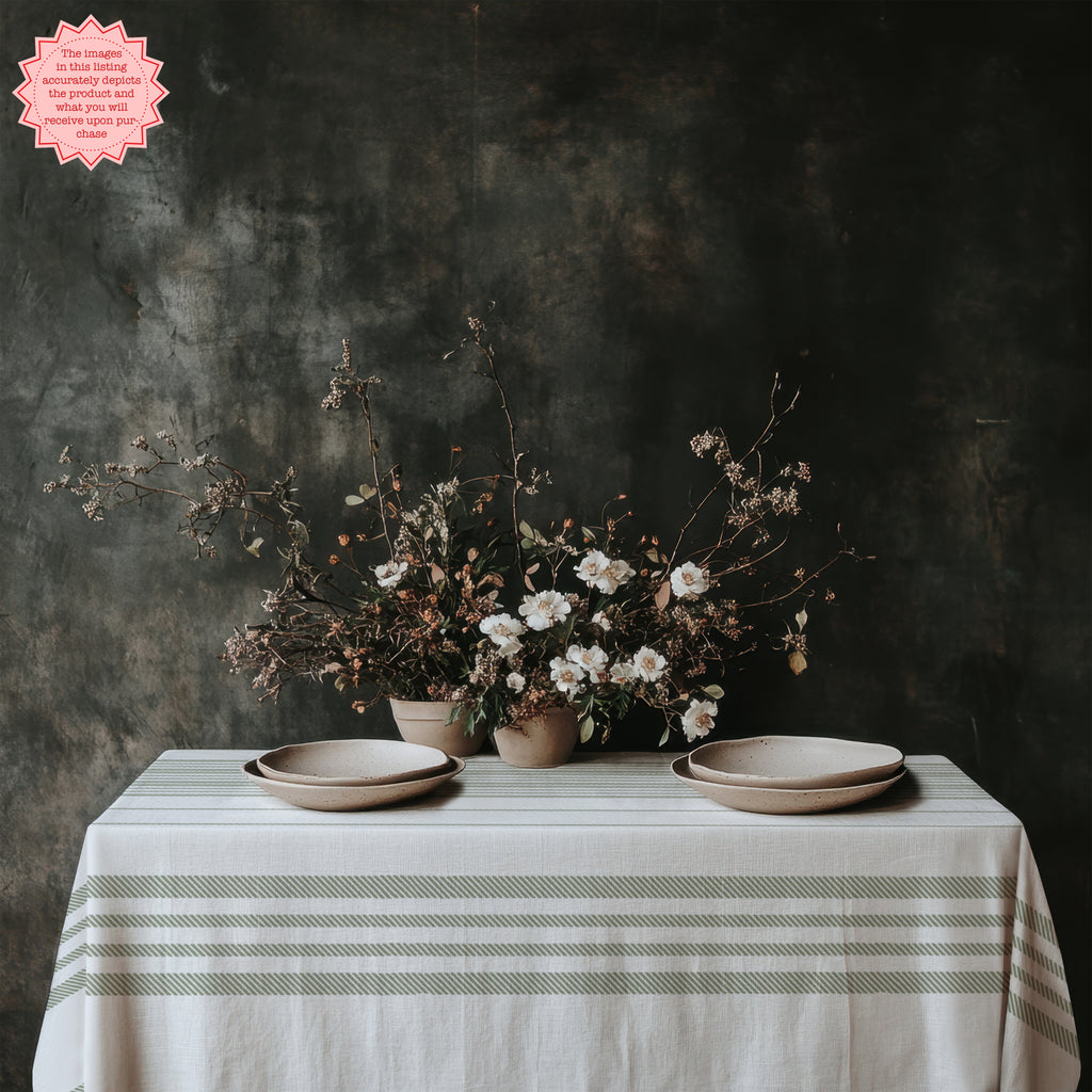 Classic sage green striped cotton tablecloth styled with linen napkins, ceramic plates, and natural textures for elegant entertaining