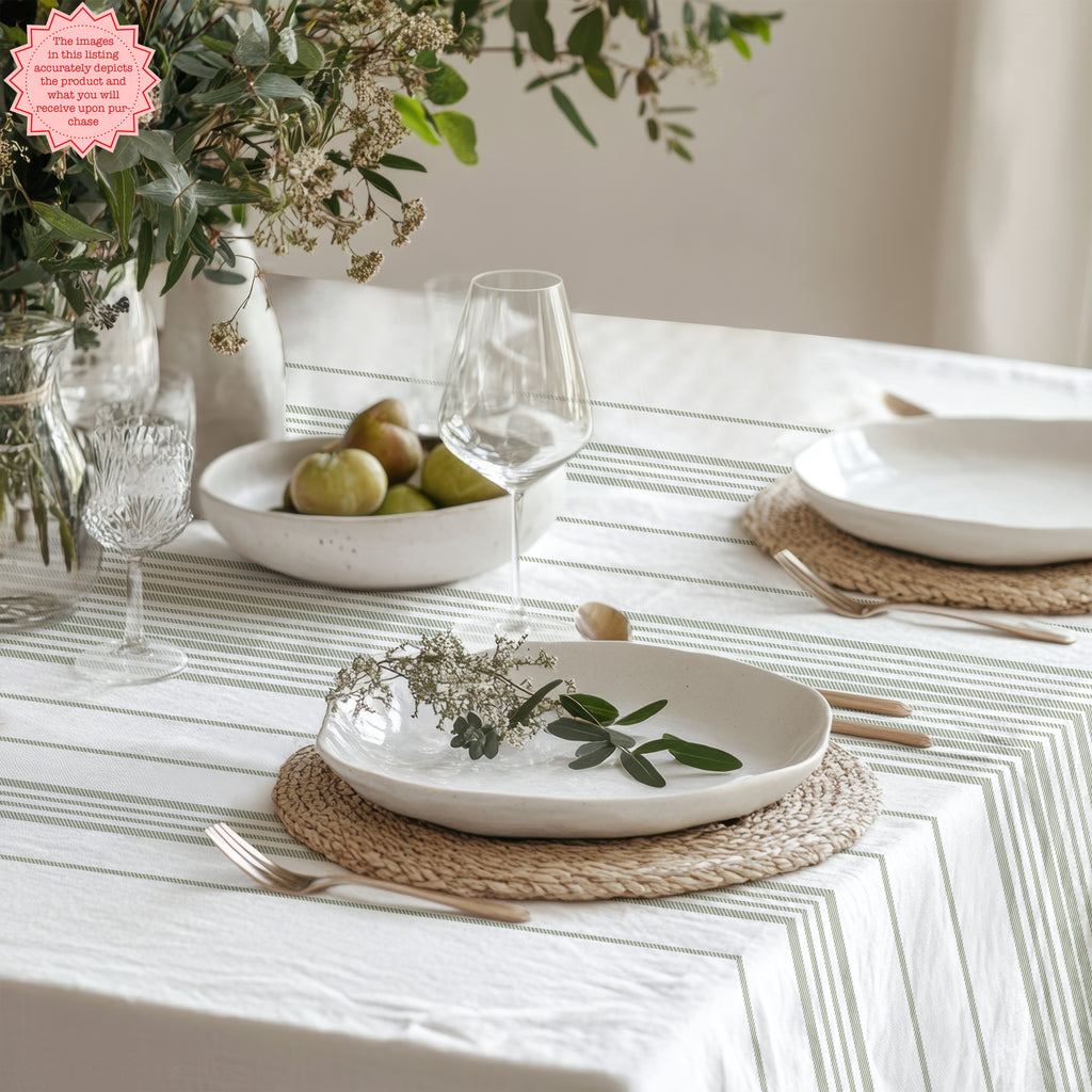 Modern Mediterranean dining room featuring a soft sage stripe tablecloth inspired by French coastal and Provence interiors.