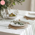 Modern Mediterranean dining room featuring a soft sage stripe tablecloth inspired by French coastal and Provence interiors.