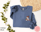 Ghost Reader Halloween crewneck sweatshirt displayed flat with embroidered ghost book design and cozy fall accessories