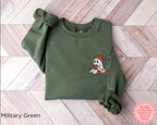 Cozy fall outfit featuring a dark embroidered ghost sweatshirt perfect for reading, Halloween and autumn days