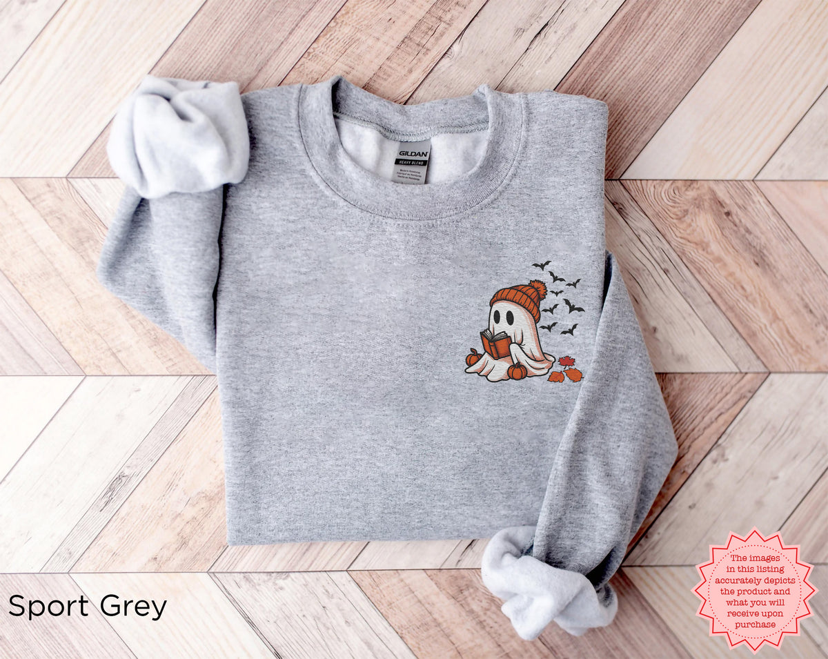 Spooky season embroidered sweatshirt with ghost reading a book design perfect for cozy autumn evenings