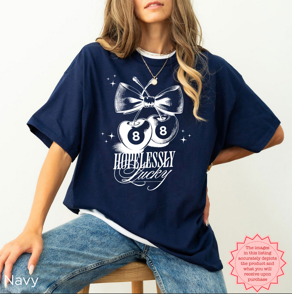 Vintage-style cherry graphic tee with a playful "Hopelessly Lucky" design, perfect for casual wear.