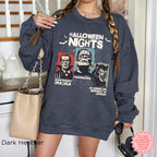 Horror Nights Halloween graphic crewneck in Dark Heather featuring three illustrated horror movie characters and bold Halloween Nights text.