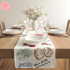 Decorative Italian table runner featuring Mediterranean-inspired artwork on a wooden dining table.