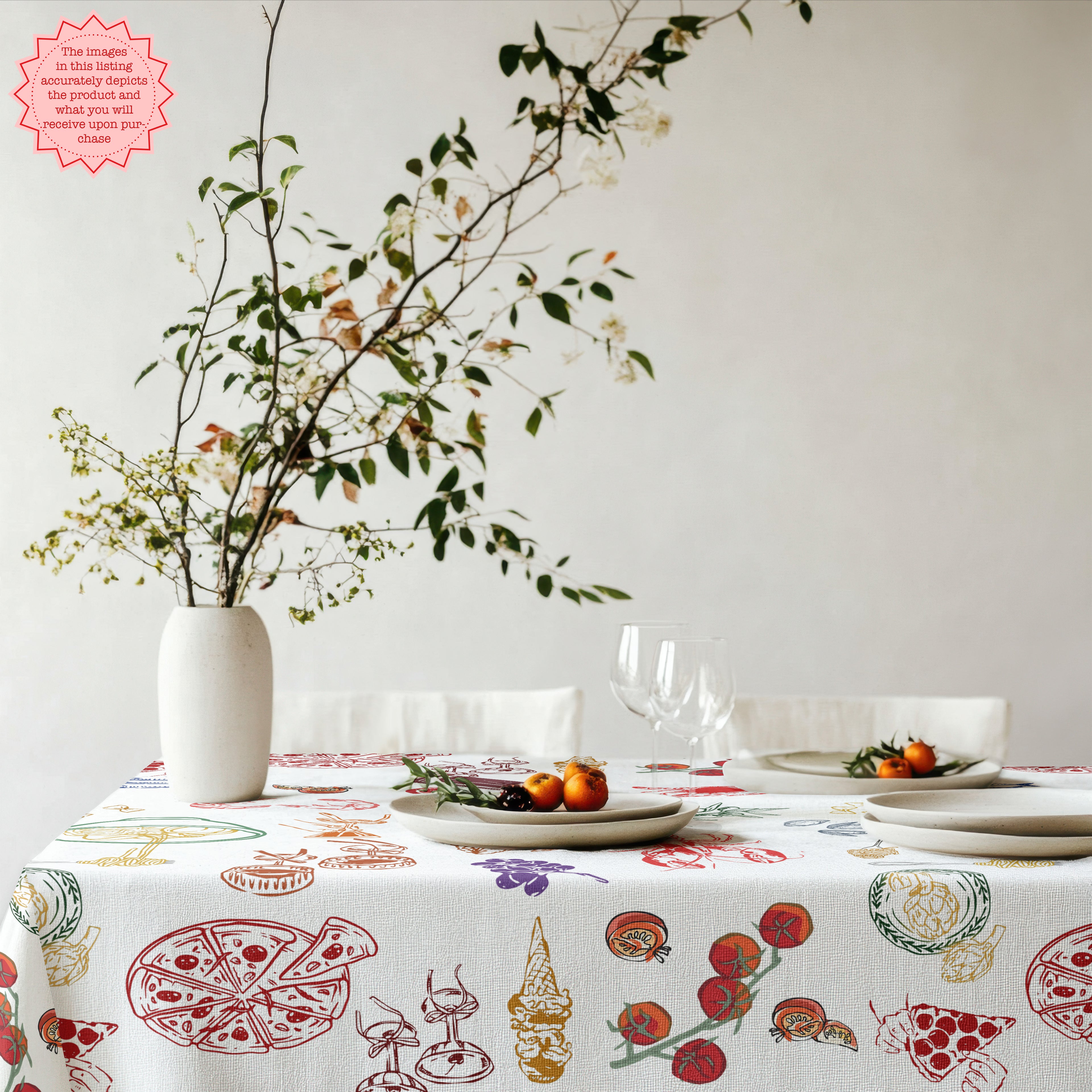 Italian-inspired dining setting featuring a Mediterranean food tablecloth with illustrated fish, seafood, vegetables and rustic ceramic tableware for summer entertaining.