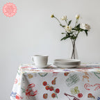 Detail view of Italian Summer Market Tablecloth pattern showing colourful hand-drawn illustrations of traditional Italian ingredients and Mediterranean lifestyle elements.