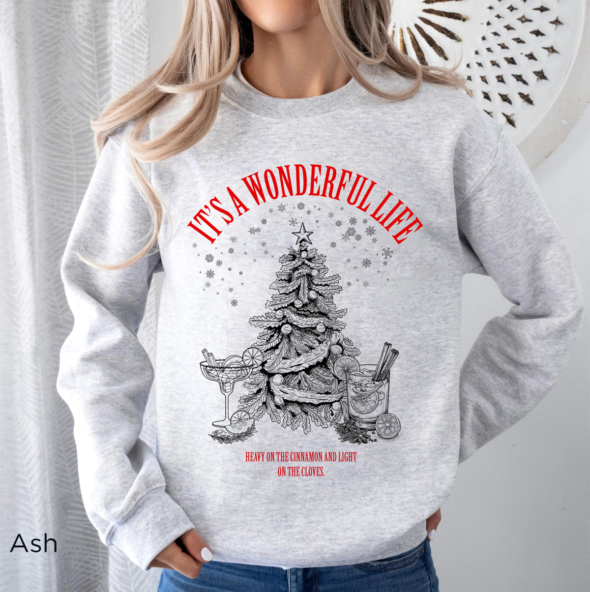 Ash white Gildan 18000 Christmas sweatshirt featuring vintage-style cream artwork of a Christmas tree, martini glass, cocktail glass and festive snowflakes.