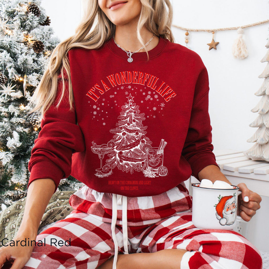 Cardinal Red Gildan 18000 Christmas cocktail sweatshirt featuring vintage-inspired cream artwork of a decorated Christmas tree, martini glass, cocktail glass and festive snowflakes.