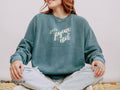 Relaxed-fit Joyeux Noël Christmas crewneck paired with casual denim for an effortless women's holiday outfit