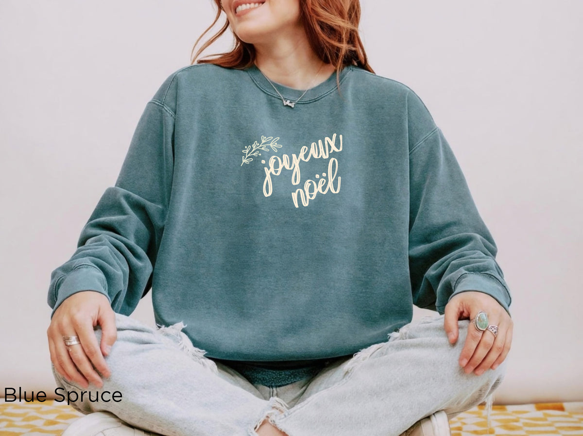 Relaxed-fit Joyeux Noël Christmas crewneck paired with casual denim for an effortless women's holiday outfit