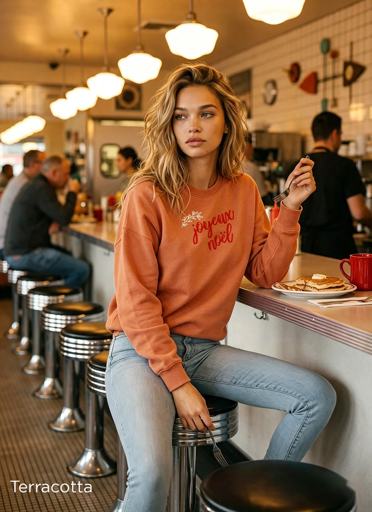 Comfort Colors 1566 Christmas crewneck in Terracotta featuring red Joyeux Noël lettering and a delicate botanical design