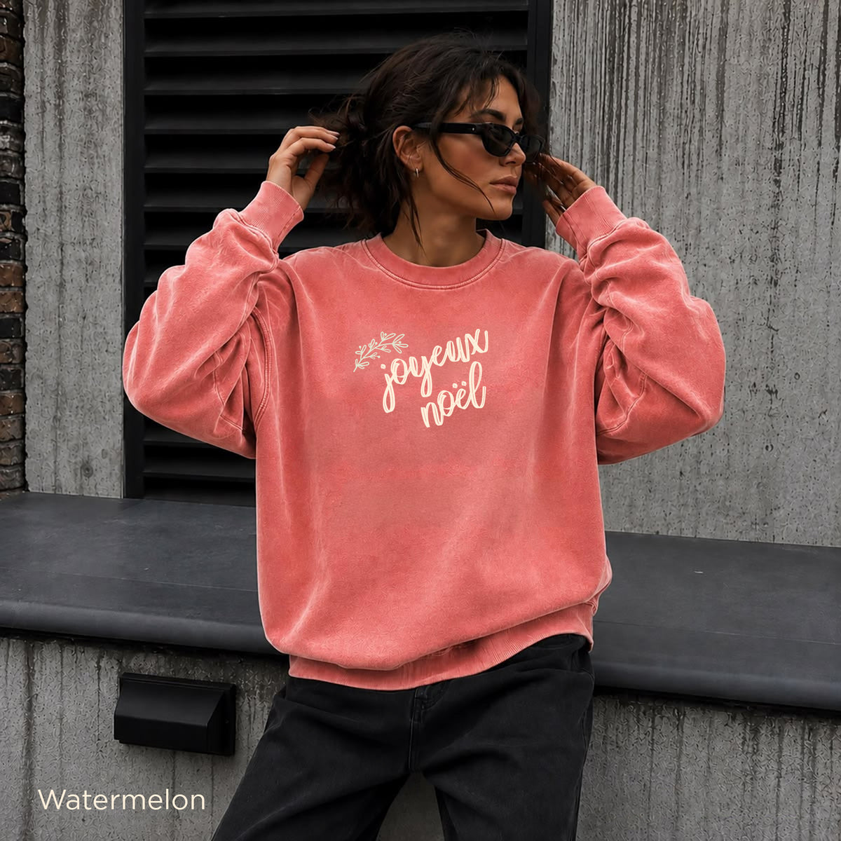 Comfort Colors 1566 Joyeux Noël sweatshirt in Watermelon with cream lettering and a subtle olive botanical accent