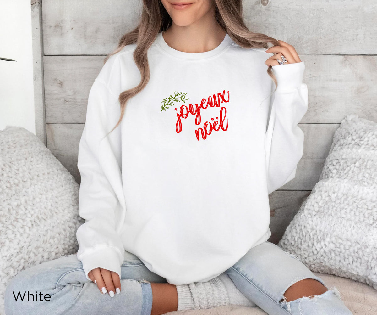 Full front view of the REBBELLA Joyeux Noël sweatshirt showcasing its minimalist French Christmas design and delicate botanical detail