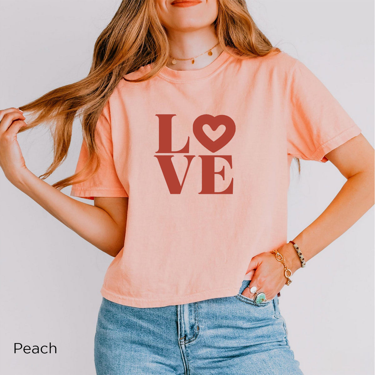 Feminine LOVE heart graphic tee in Peach with bold terracotta typography