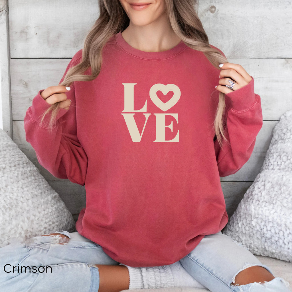 Woman wearing Crimson LOVE graphic sweatshirt with relaxed coastal style
