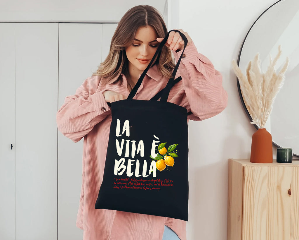 Natural cotton canvas tote bag featuring La Vita è Bella typography and hand-painted Mediterranean lemons inspired by the Italian coast.