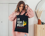 Natural cotton canvas tote bag featuring La Vita è Bella typography and hand-painted Mediterranean lemons inspired by the Italian coast.