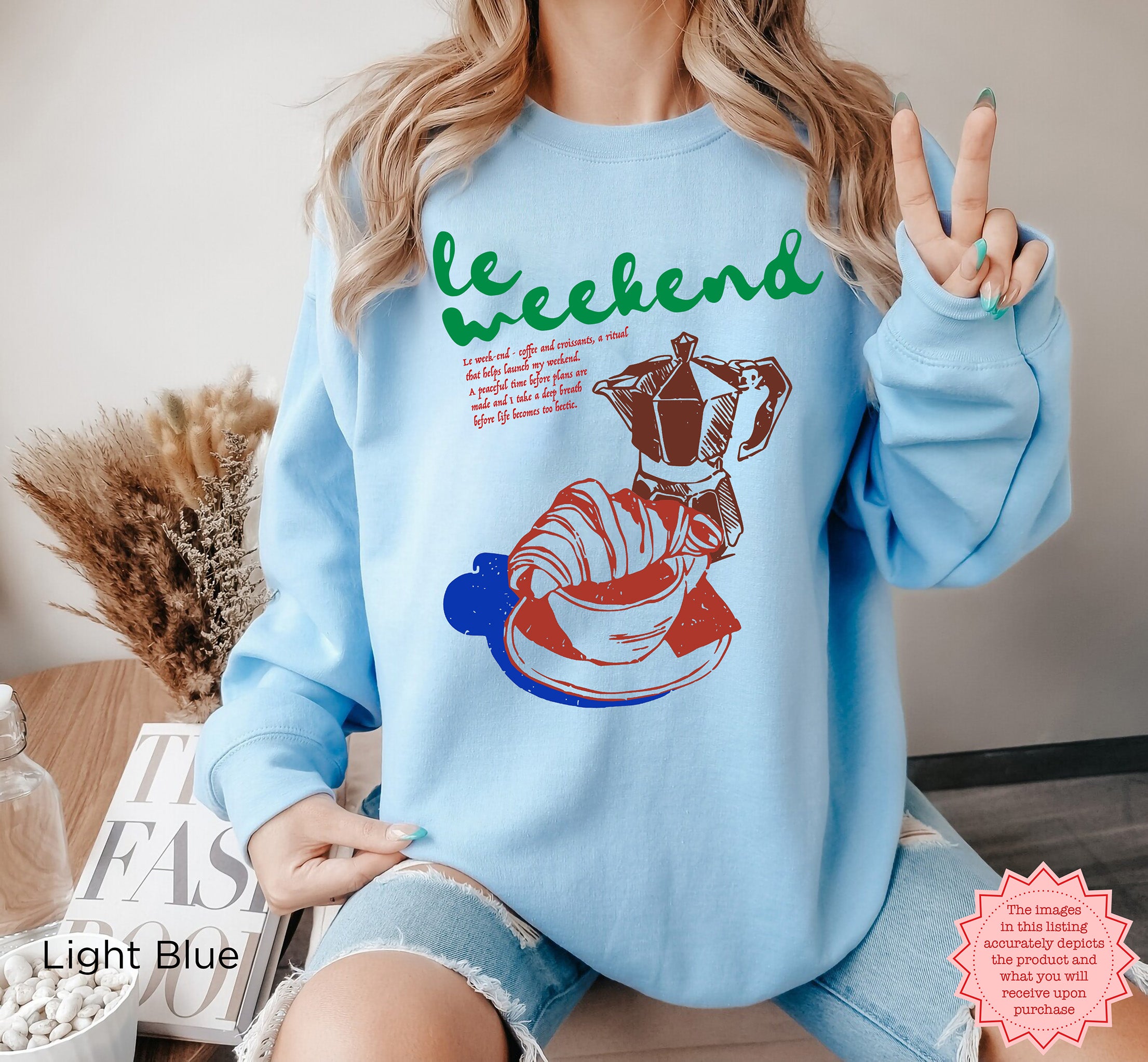 Cozy sweatshirt featuring French-inspired coffee and croissant graphic, perfect for weekends.