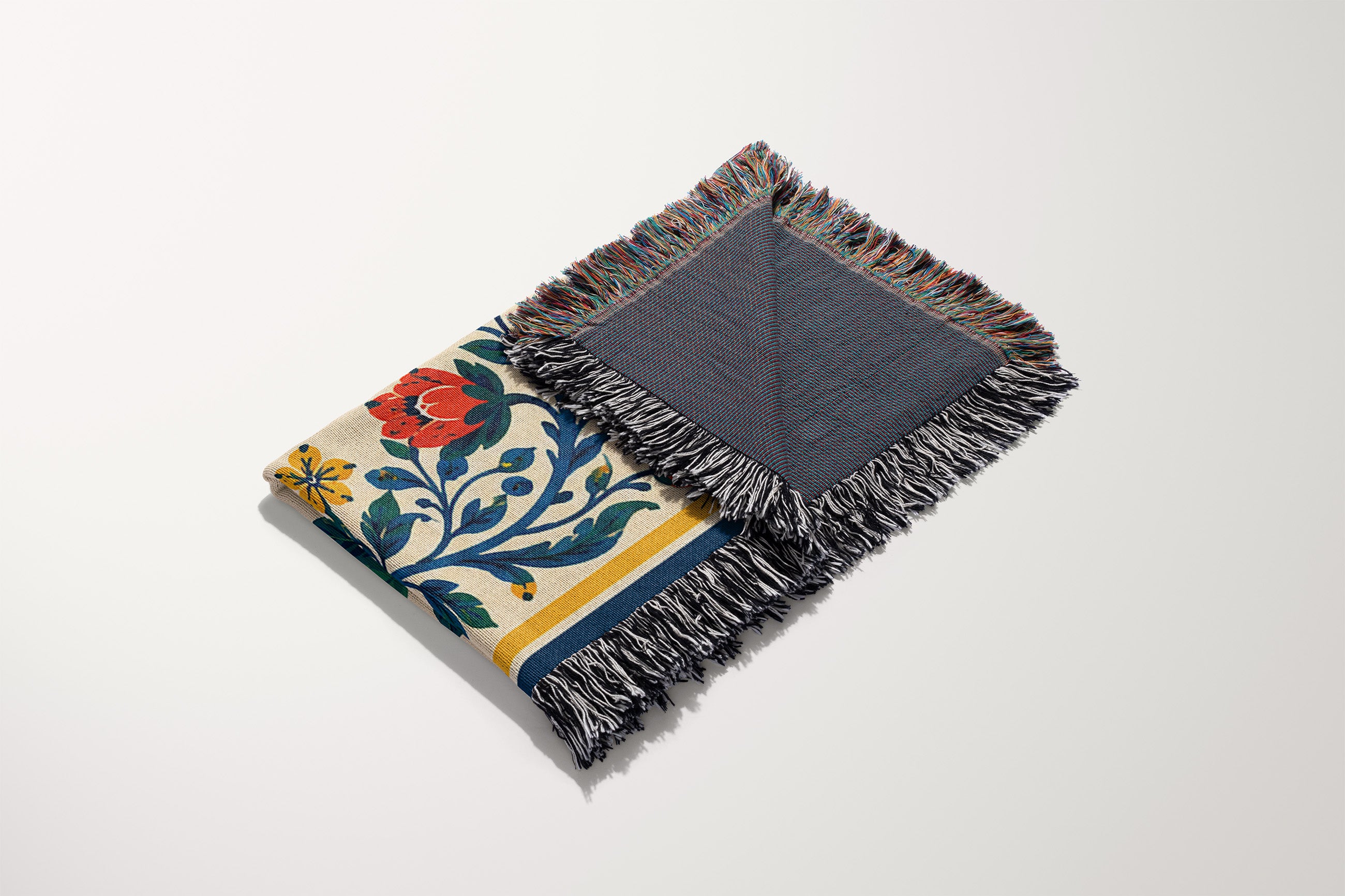 Close-up view of woven cotton threads and colorful fringed edges on an Amalfi inspired lemon blanket