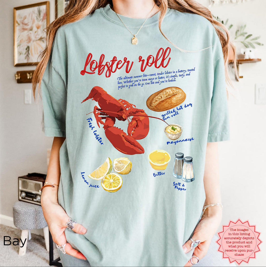 Unisex Comfort Colors 1717 t-shirt in Bay blue with colorful lobster roll graphic, fresh lobster, bread, lemon, and condiments illustration, styled for coastal seafood lovers.