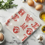 Cotton tea towel styled on marble countertop with herbs and olive oil
