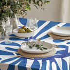 Modern Mediterranean dining table styled with blue abstract cotton tablecloth and neutral ceramics