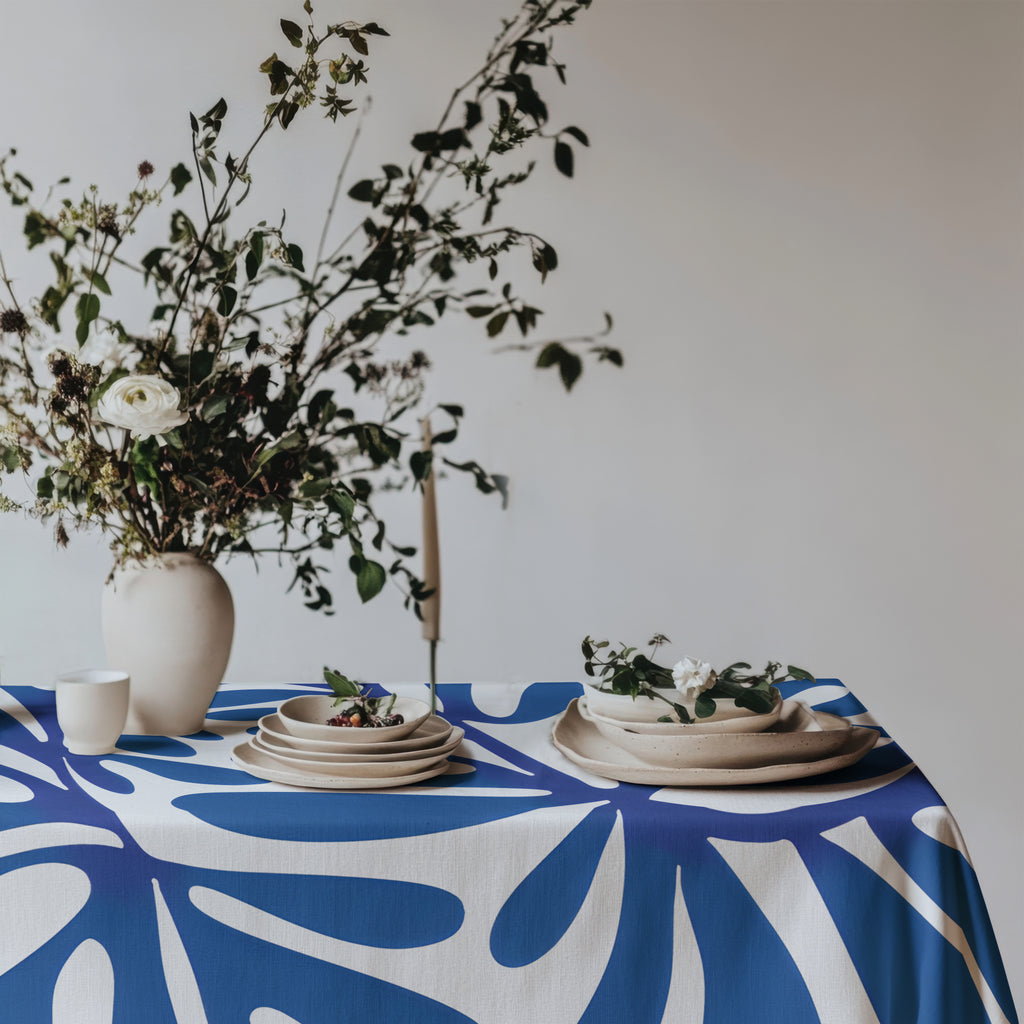 Mediterranean style dining table featuring a modern blue statement tablecloth