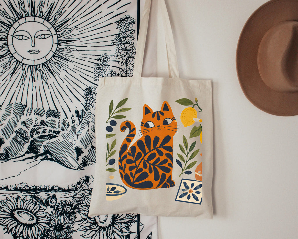 Mediterranean lifestyle tote bag featuring a colorful Matisse-inspired cat surrounded by olives, lemons, and traditional tile motifs.