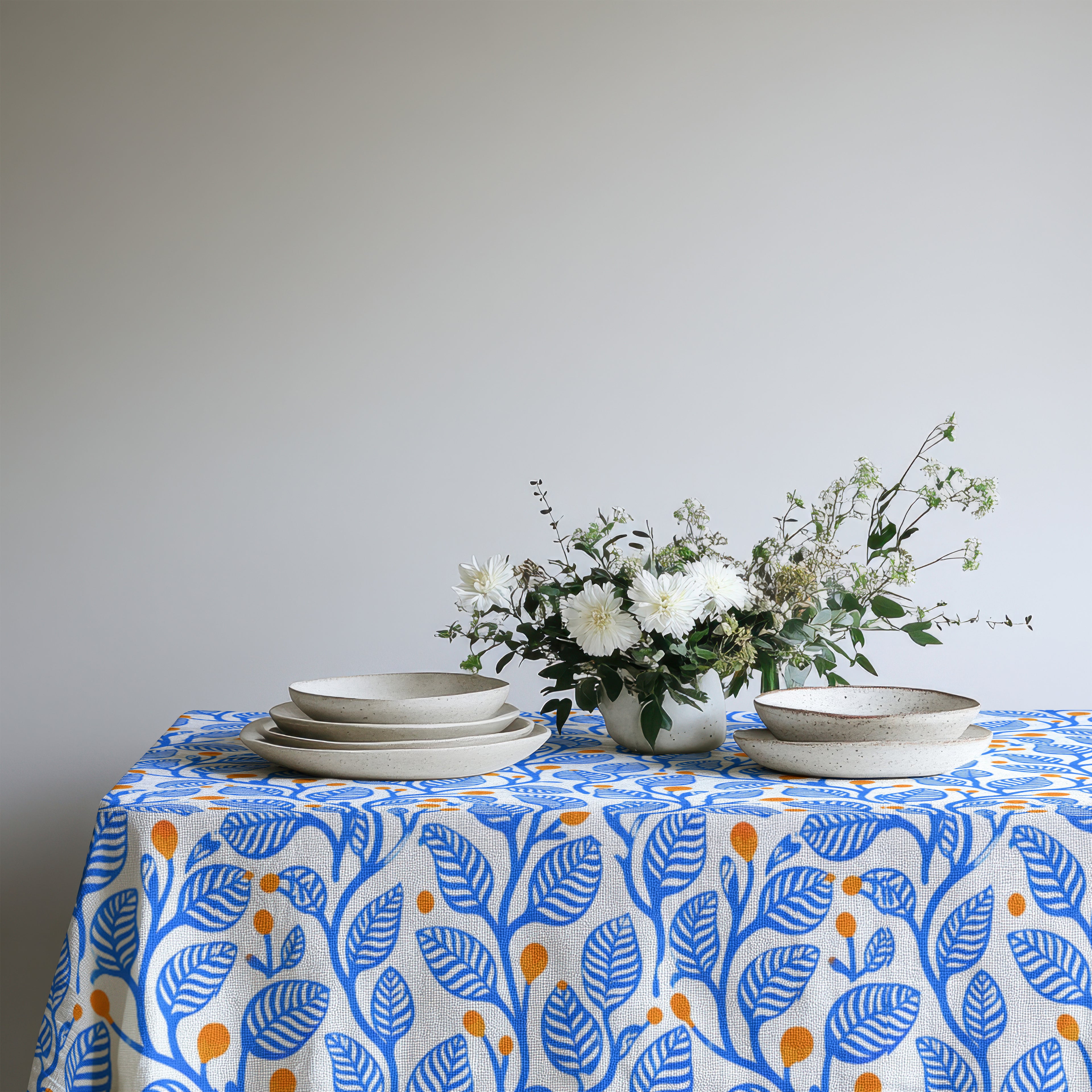 Blue botanical tablecloth designed for Mediterranean-style dining rooms and contemporary tablescapes.