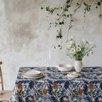 Mediterranean botanical tablecloth with modern floral pattern in rich natural tones on cotton twill fabric.