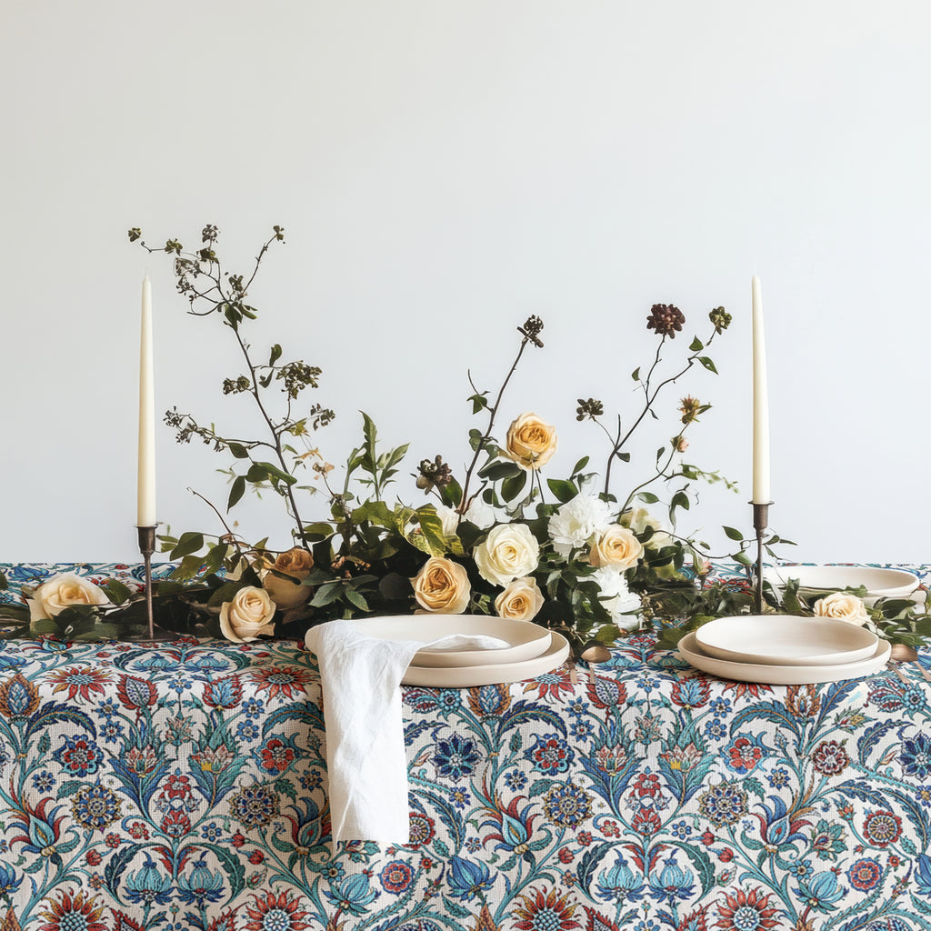 Ottoman inspired floral table linen styled with woven placemats and white ceramic plates