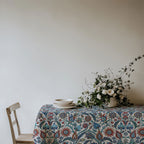 Mediterranean cotton tablecloth featuring intricate blue, red and turquoise floral pattern