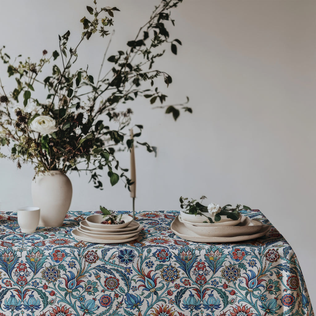 Mediterranean dining table decorated with Turkish inspired floral cotton tablecloth and fresh greenery