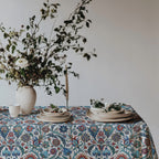 Mediterranean dining table decorated with Turkish inspired floral cotton tablecloth and fresh greenery