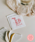 6.5 x 6.5 inch white luncheon napkin with Merrier with a Tini personalised Christmas design, ideal for festive meals and appetisers.