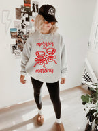 Ash Gildan 18000 crewneck sweatshirt featuring the “Merrier with a Martini” Christmas cocktail design, festive holiday apparel.