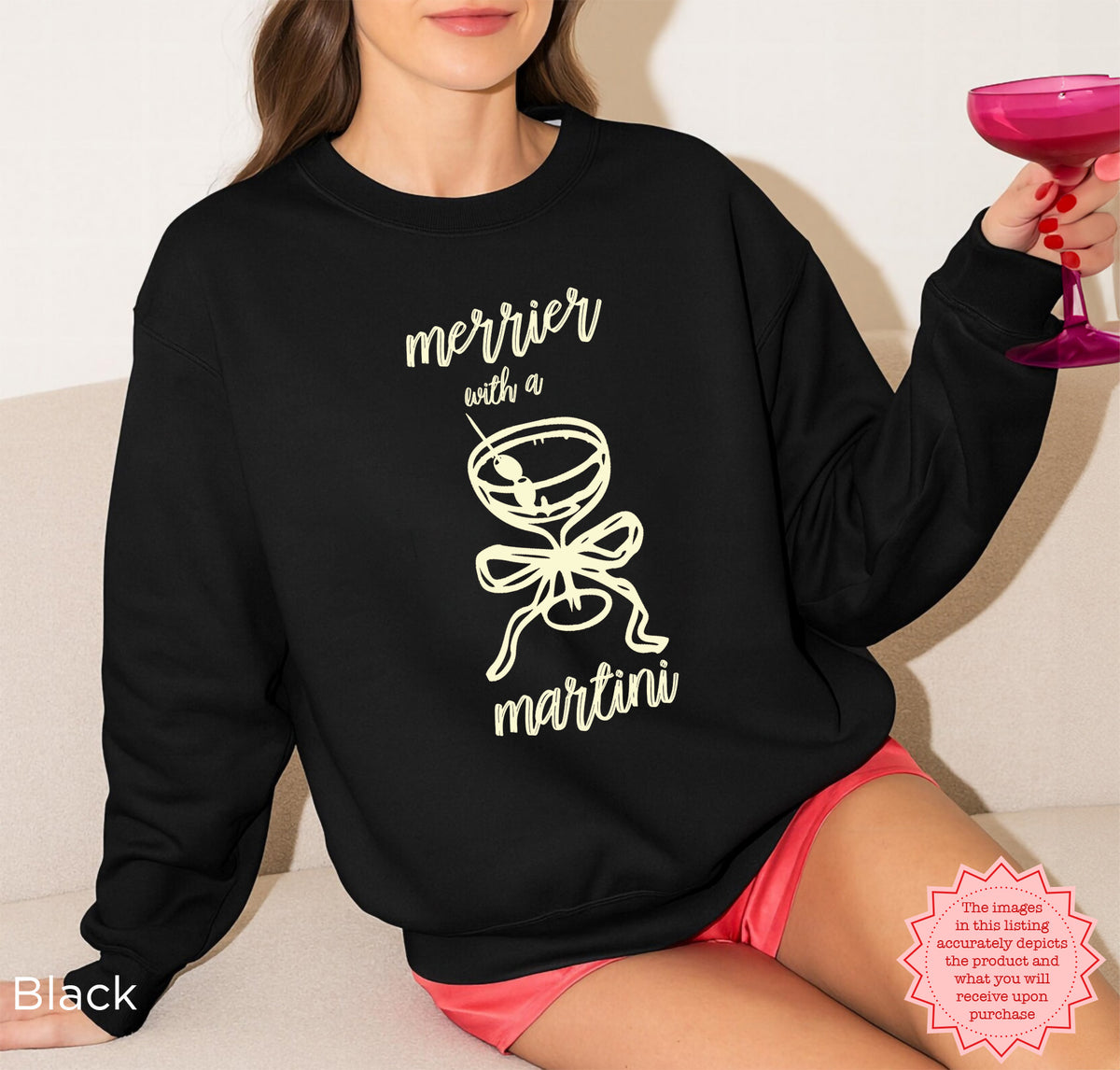 Black Gildan 18000 crewneck sweatshirt with the Merrier With A Martini Christmas cocktail graphic, cute coquette holiday apparel.