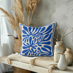Mediterranean inspired abstract cushion styled for contemporary living room décor with organic flowing shapes.