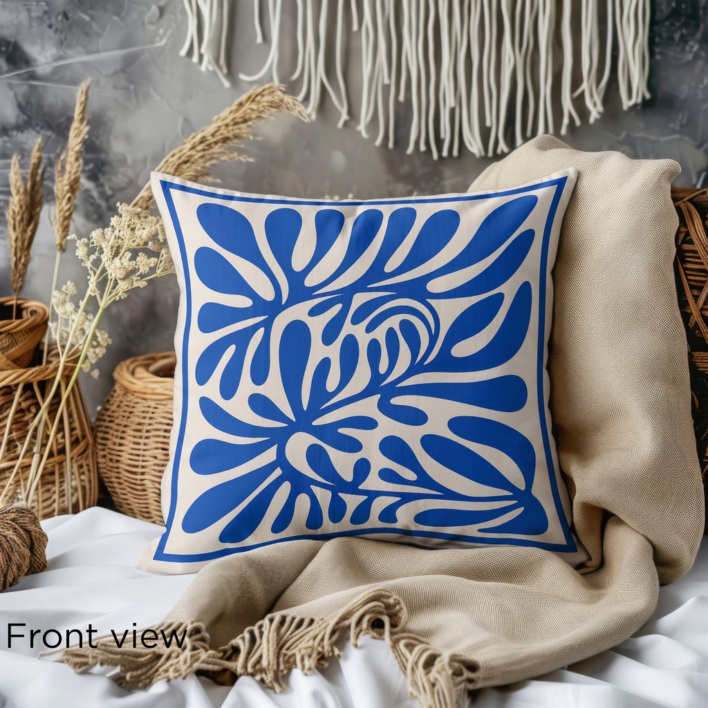 Close-up of blue faux suede throw pillow showing abstract botanical artwork and premium fabric texture.